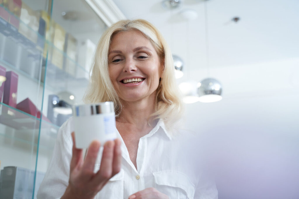 Smiling mature woman holding an eco-friendly jar of cream