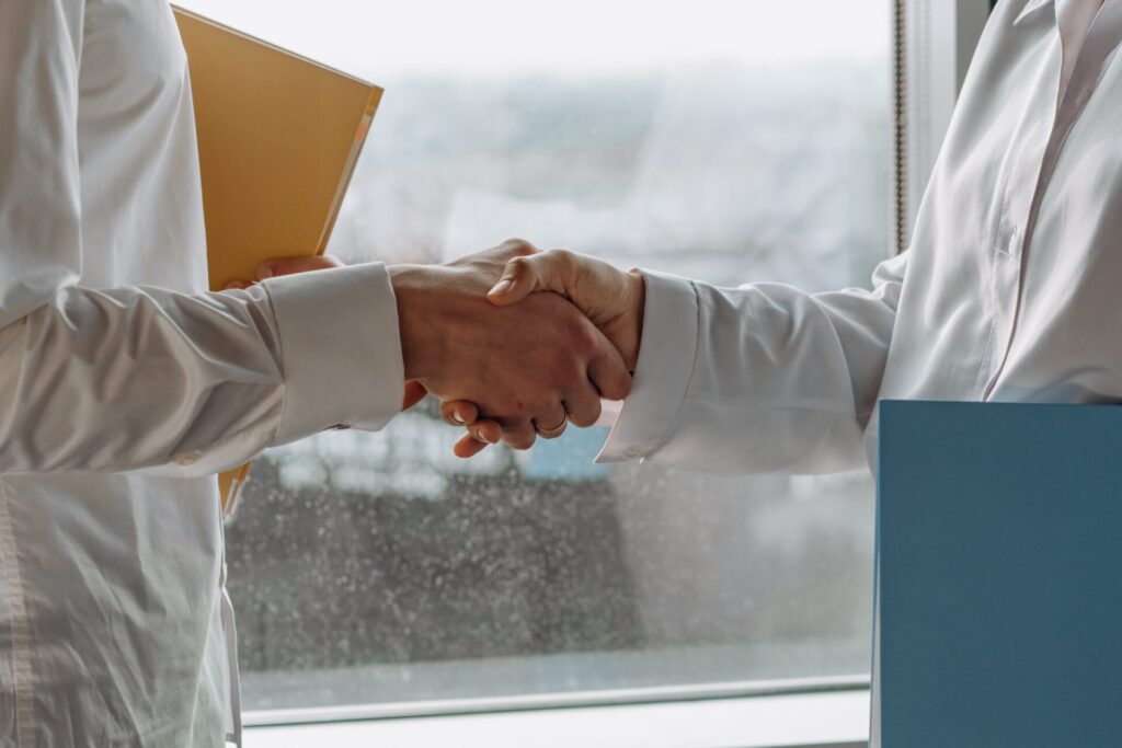 two people shake hands