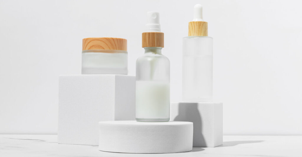 Cosmetics packaging. Set of different cosmetic jars and tubes of cream on white podiums. Blank packaging. Natural beauty spa product concept. Beauty.Mock up